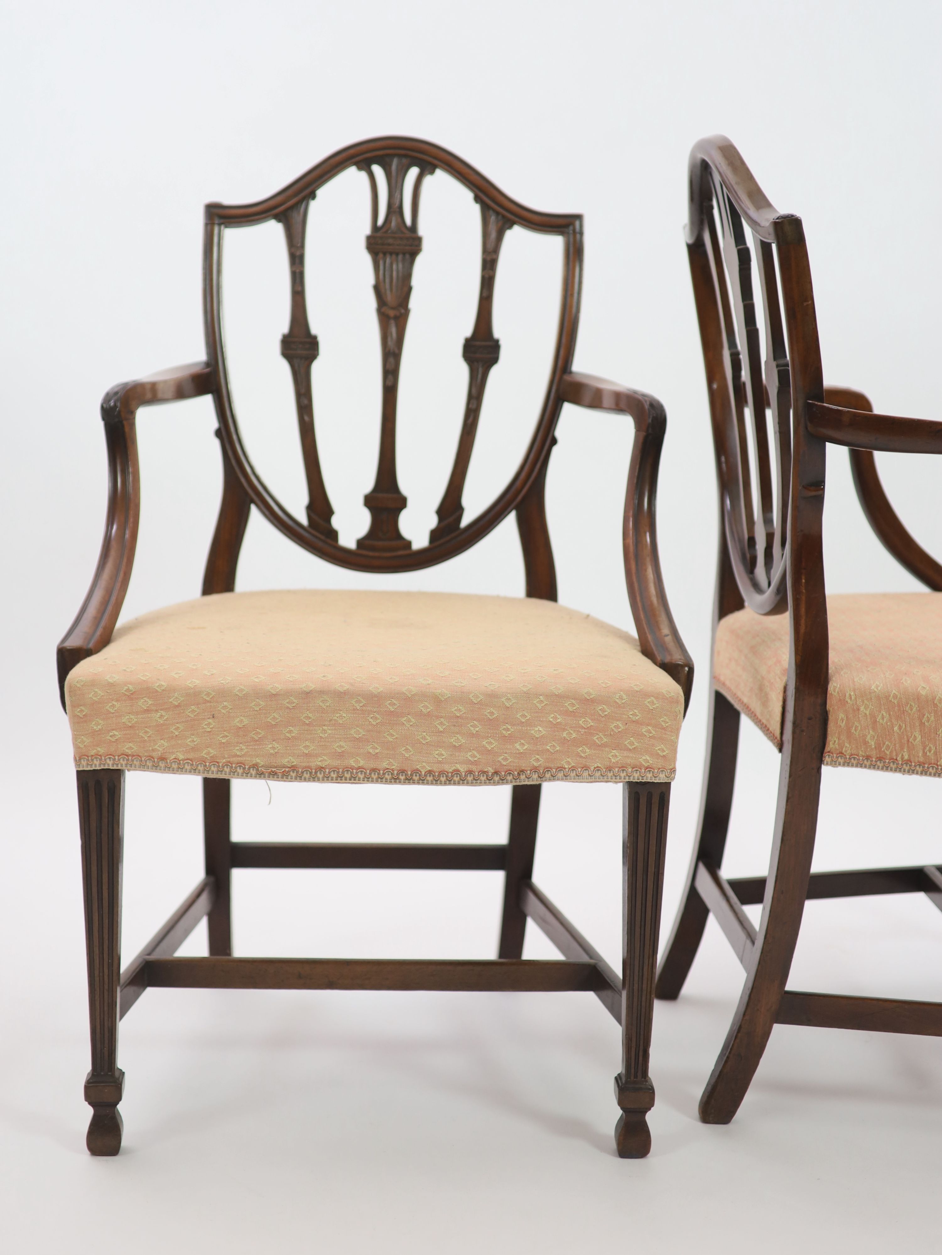 A pair of George III Hepplewhite style mahogany shield back elbow chairs, W.62cm H.97cm